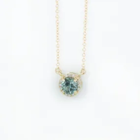 0.56ct Montana Sapphire and diamond halo necklace in 14k yellow